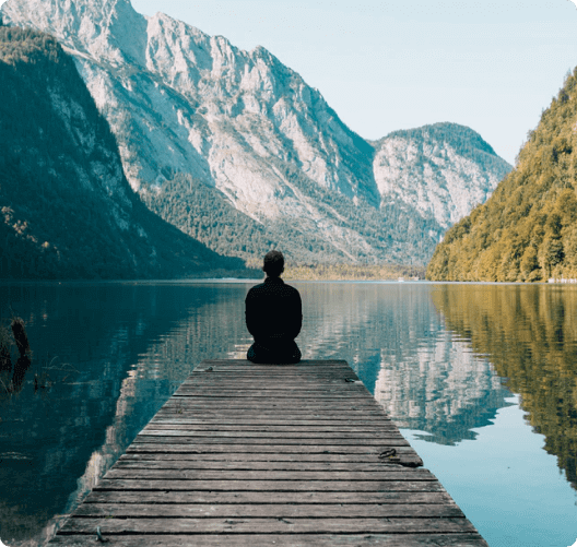 man sitting at lake